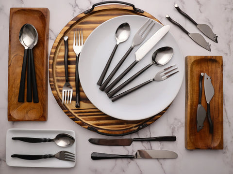 An assortment of handcrafted black flatware